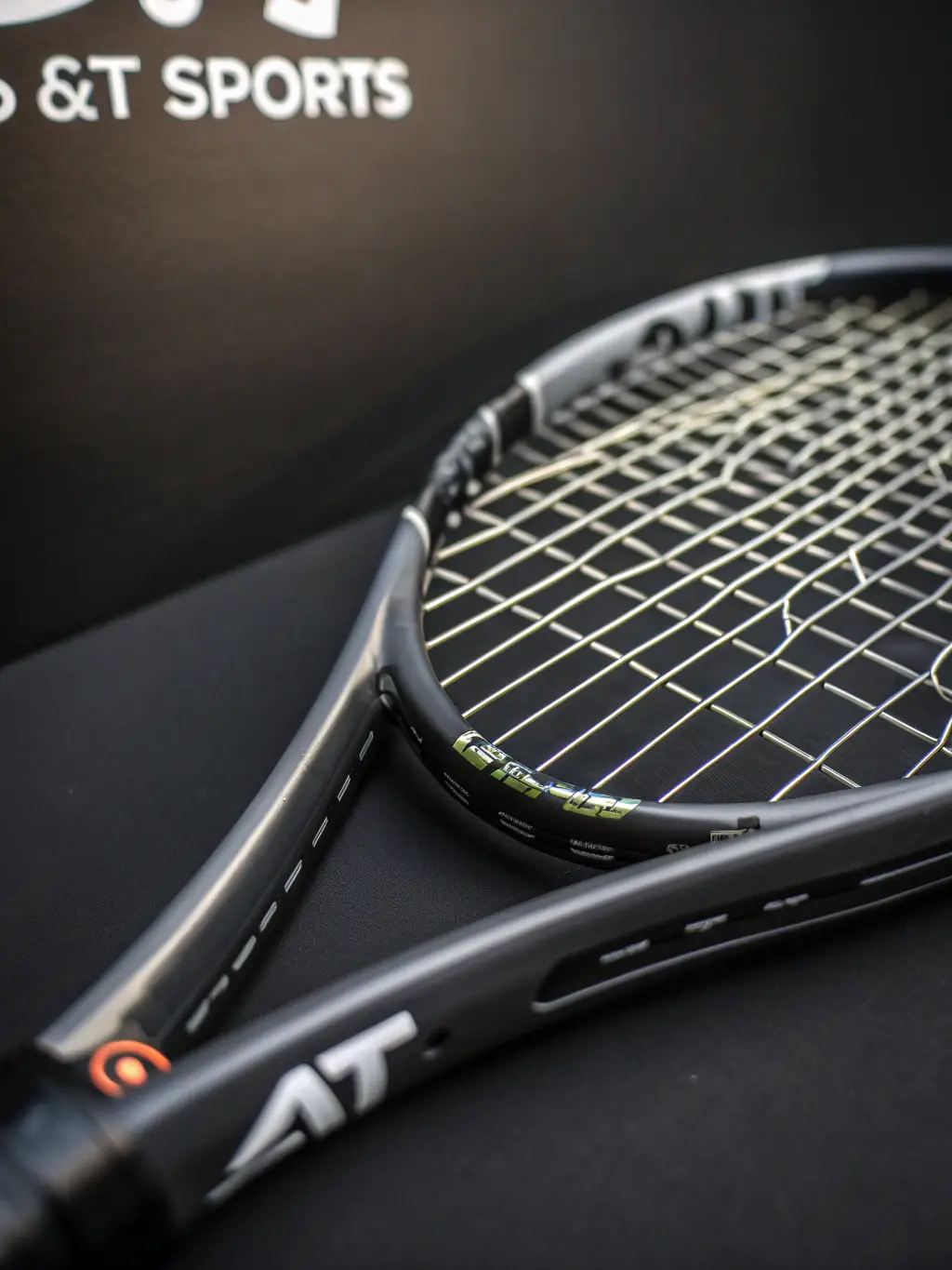 A close-up shot of a tennis player's hand gripping a racket firmly, ready to serve, symbolizing the focus on skill development and competitive play at ASSOCIATION SPORTIVE D'ORGIBET.
